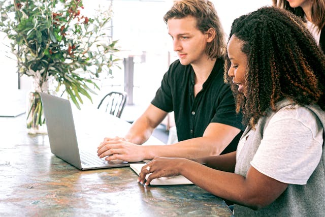 Two people working on a computer