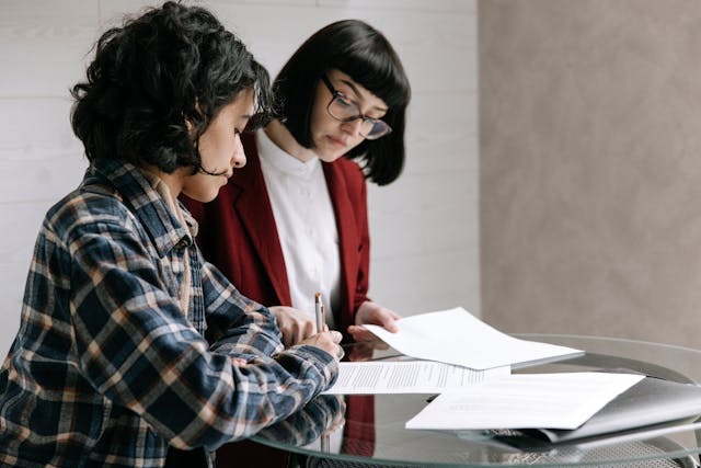 Two people reading over documents