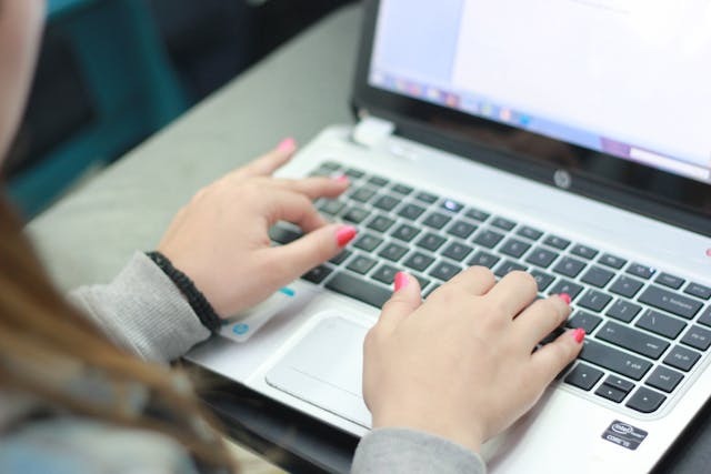 person typing on a laptop