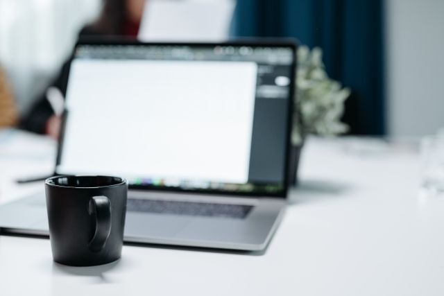 a mug infront of a laptop