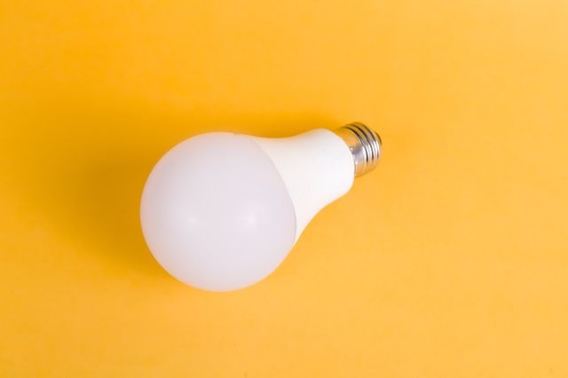 LED lightbulb sitting on a yellow table