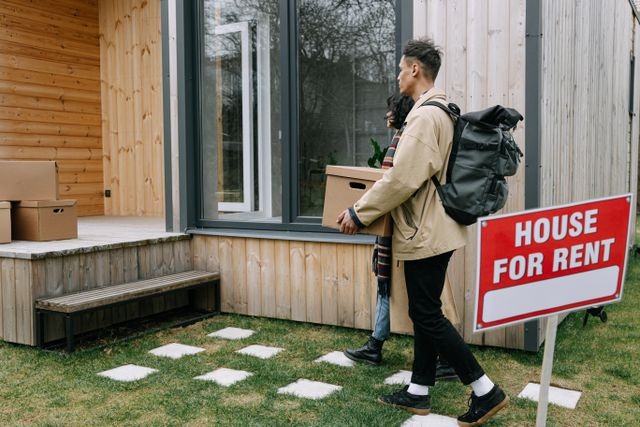 tenants walking behind a house for rent sign
