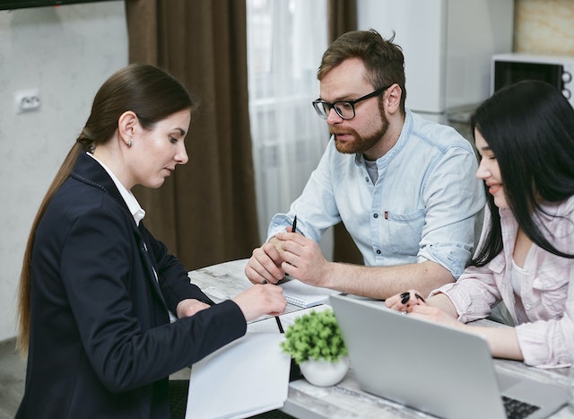 a mortgage lender going over financing options with potential buyers