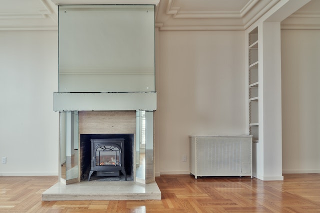 an empty property with wood floors and a white fireplace