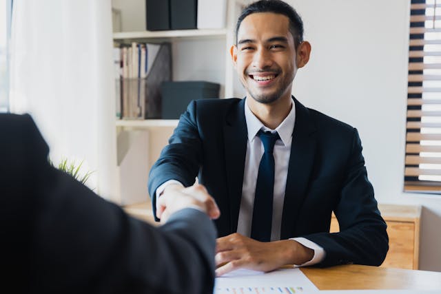 bank teller shaking hands with a tenant