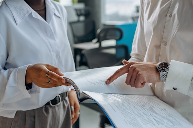 close-up of two legal experts looking over a contract