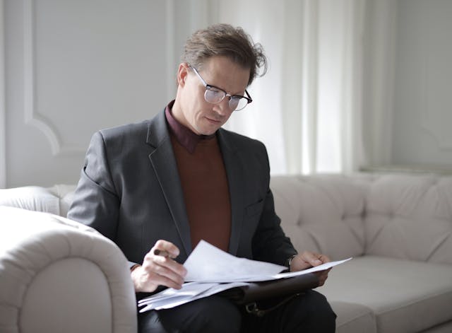 person reading through a stack of documents
