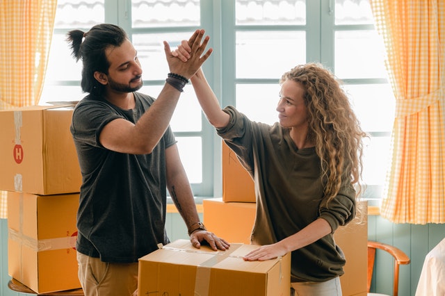 couple moving in and giving a high-five