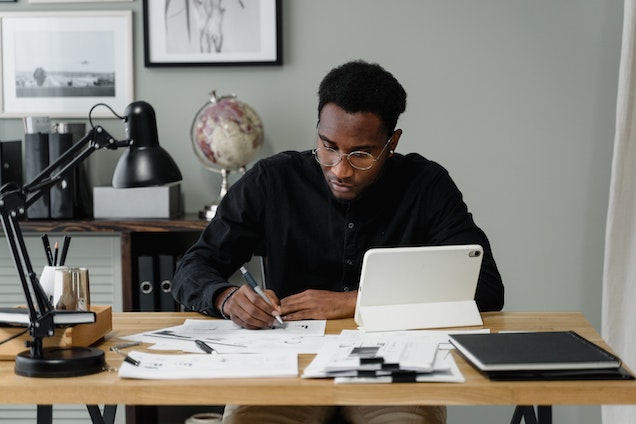 property manager sitting at their desk with their computer and a notepad in front of them