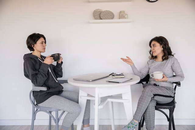 two people talking over coffee